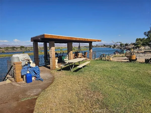 a view of a house with backyard porch and sitting area