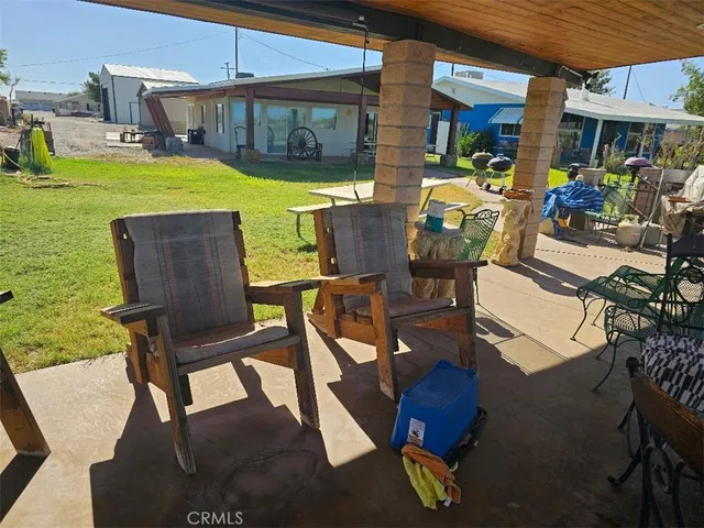 a view of an chairs and table in the patio
