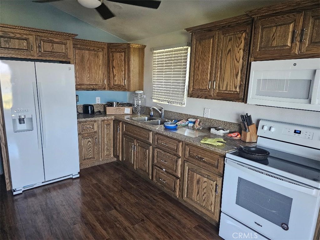 5180 Colorado River Road Blythe, CA 92225 - Photo 7 of 11 a kitchen with stainless steel appliances granite countertop a stove a sink dishwasher a refrigerator and cabinets with wooden floor
