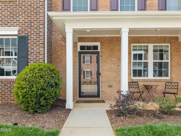 a front view of a brick house with a yard