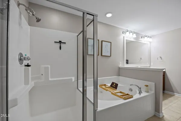 a bathroom with a tub a sink and a shower