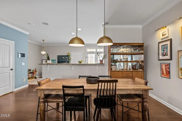 a view of a dining room with furniture and chandelier