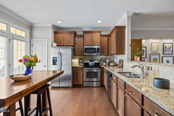 a kitchen with granite countertop counter space a sink appliances and cabinets