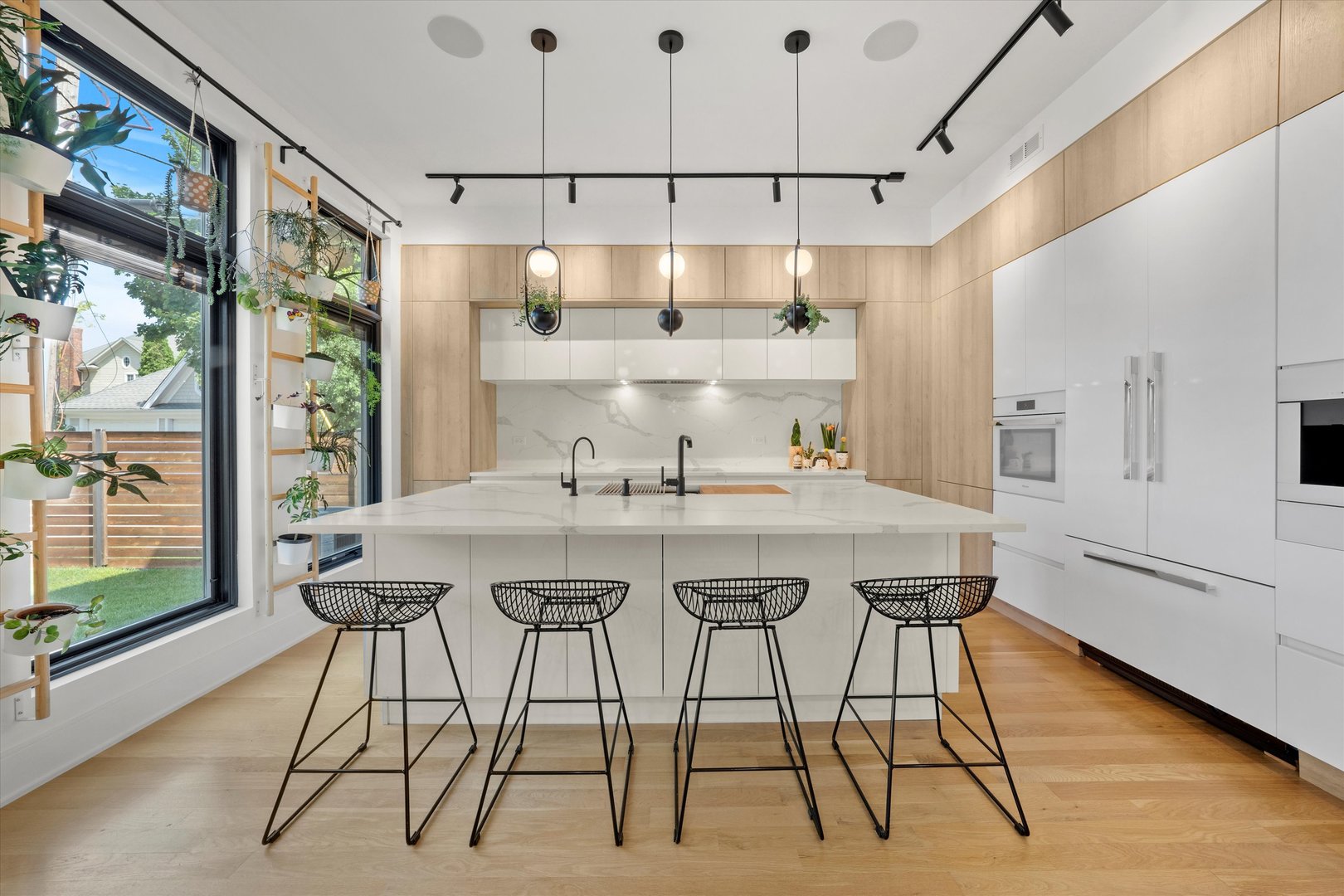 215 Eagle Street Naperville, IL 60540 - Photo 14 of 50 a view of a kitchen with kitchen island stainless steel appliances a table and chairs in it