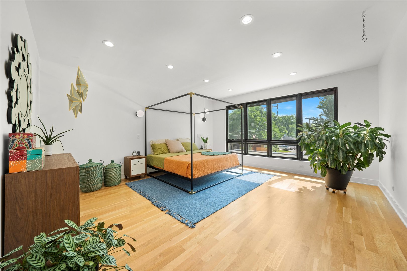 215 Eagle Street Naperville, IL 60540 - Photo 21 of 50 a spacious bedroom with a bed and a potted plant