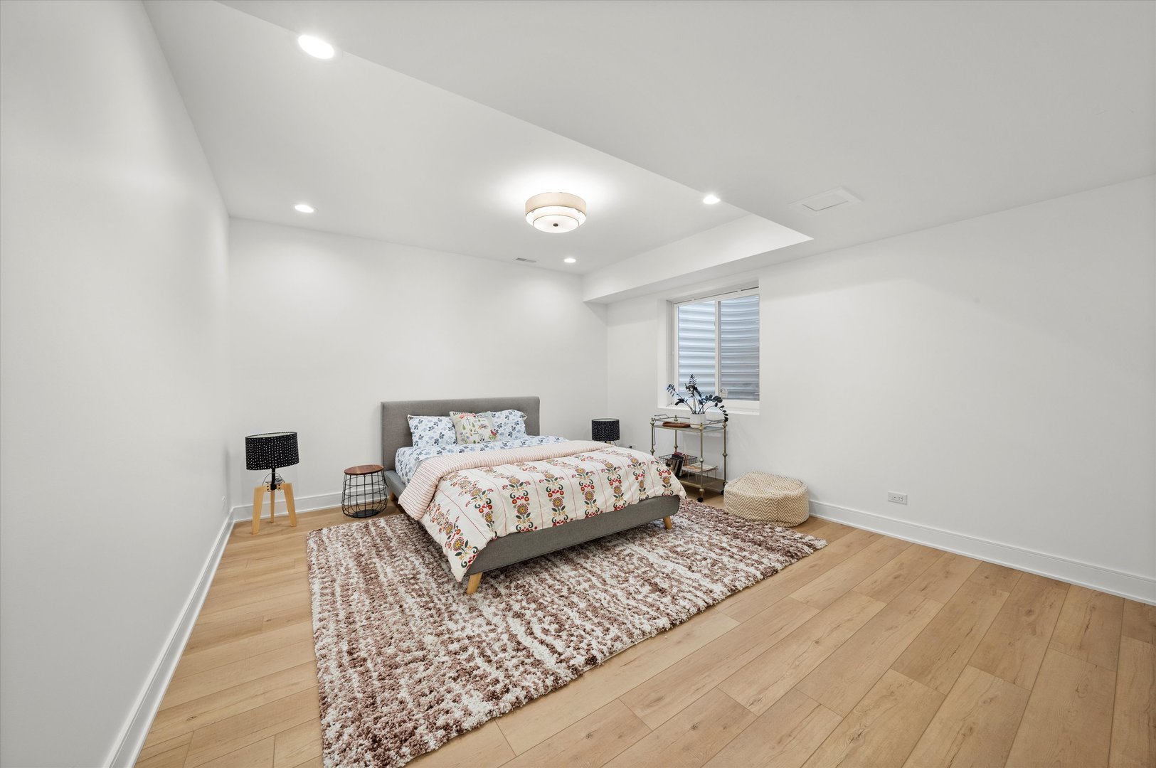 215 Eagle Street Naperville, IL 60540 - Photo 38 of 50 a bedroom with a large bed and a wooden floor