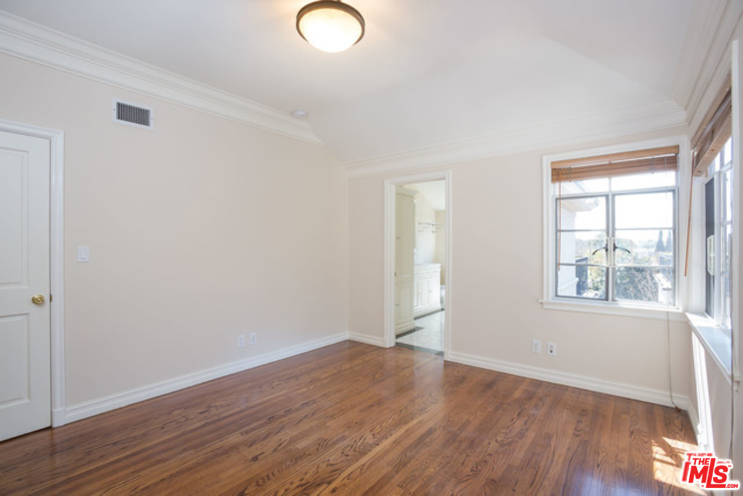 171 South Rodeo Drive Beverly Hills, CA 90212 - Photo 11 of 21 an empty room with wooden floor and windows