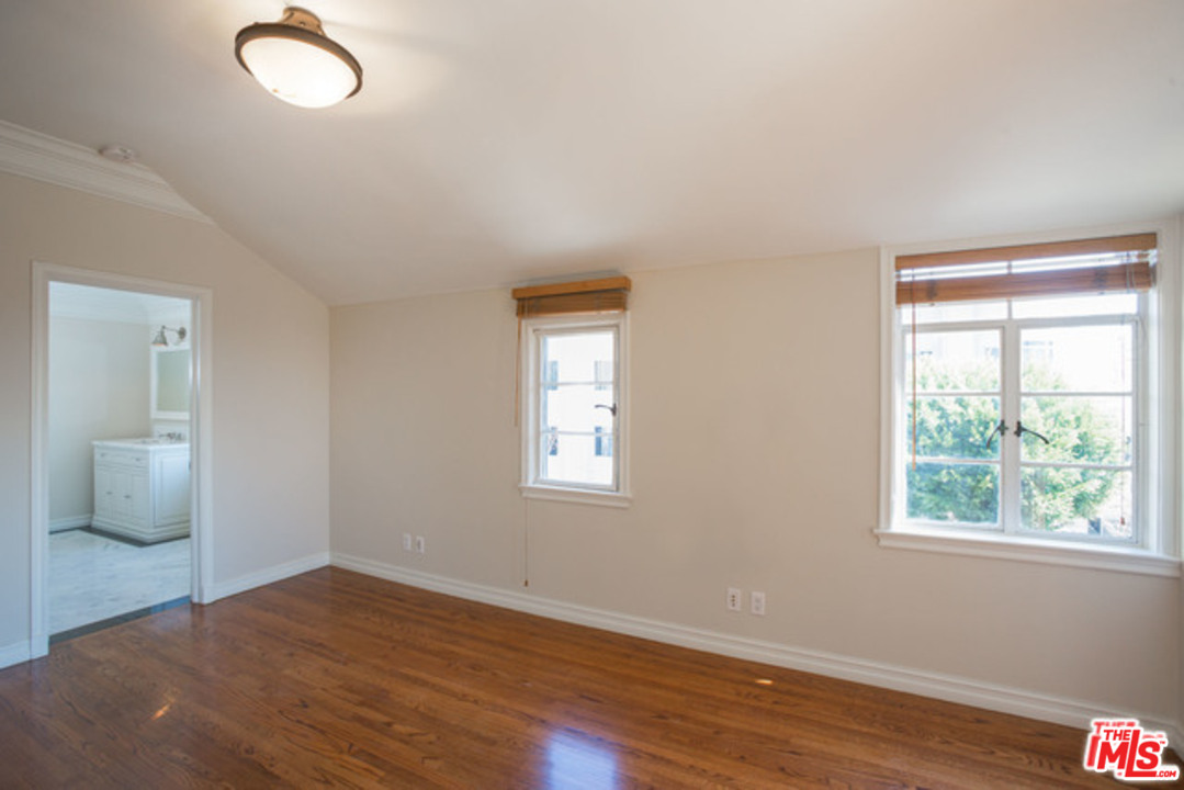 171 South Rodeo Drive Beverly Hills, CA 90212 - Photo 18 of 21 a view of an empty room with wooden floor and a window