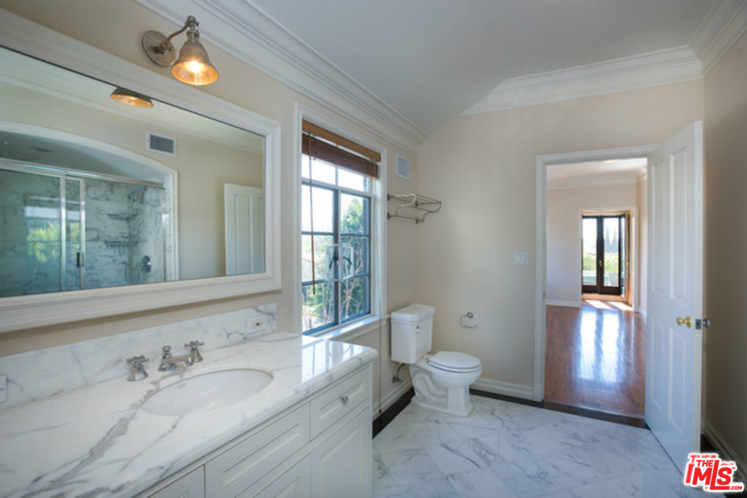 171 South Rodeo Drive Beverly Hills, CA 90212 - Photo 20 of 21 a spacious bathroom with a toilet sink and mirror