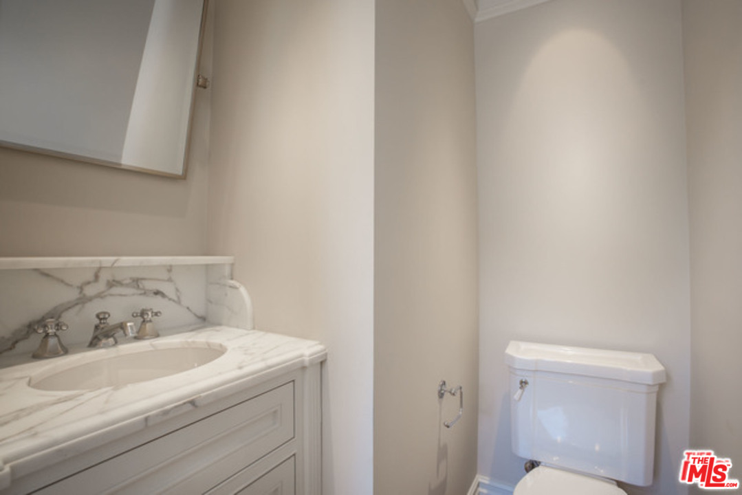 171 South Rodeo Drive Beverly Hills, CA 90212 - Photo 5 of 21 a bathroom with a sink and a toilet