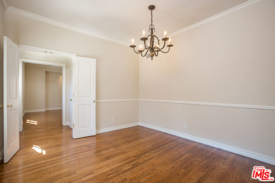 171 South Rodeo Drive Beverly Hills, CA 90212 - Photo 6 of 21 a view of a room with wooden floor and chandelier