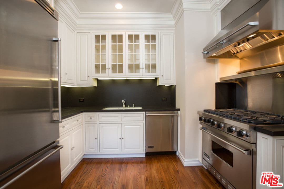 171 South Rodeo Drive Beverly Hills, CA 90212 - Photo 7 of 21 a kitchen with granite countertop a stove and a sink