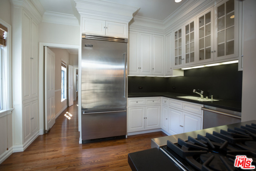 171 South Rodeo Drive Beverly Hills, CA 90212 - Photo 8 of 21 a kitchen with cabinets and stainless steel appliances