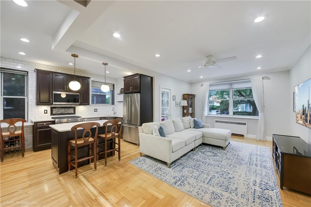 8701 Shore Road, Unit 137 Brooklyn, NY 11209 - Photo 1 of 11 a living room with furniture and a flat screen tv