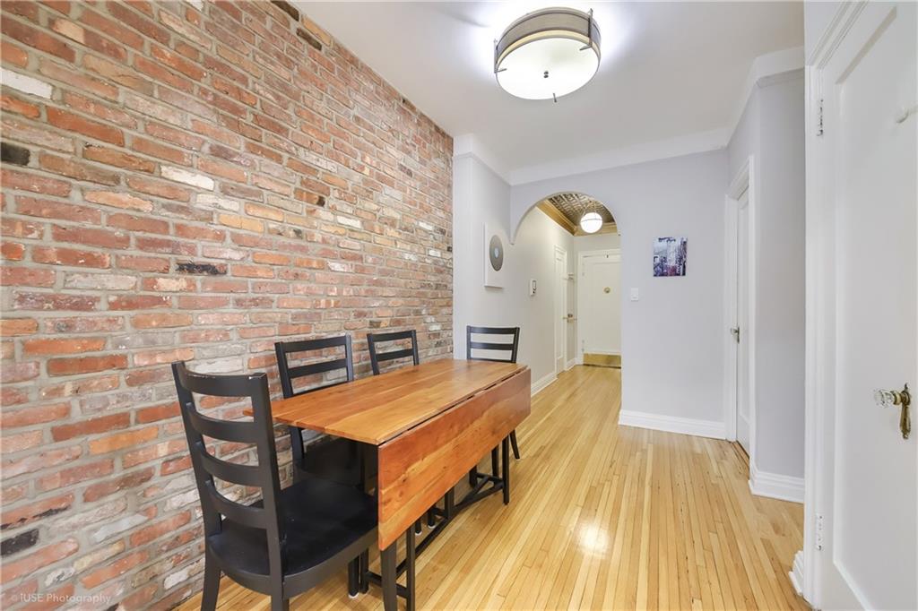 8701 Shore Road, Unit 137 Brooklyn, NY 11209 - Photo 2 of 11 wooden floor with a table and chairs in it