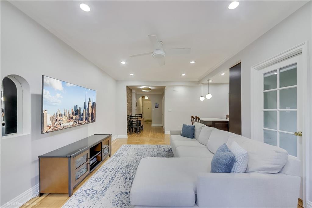 8701 Shore Road, Unit 137 Brooklyn, NY 11209 - Photo 8 of 11 a living room with furniture and a large window