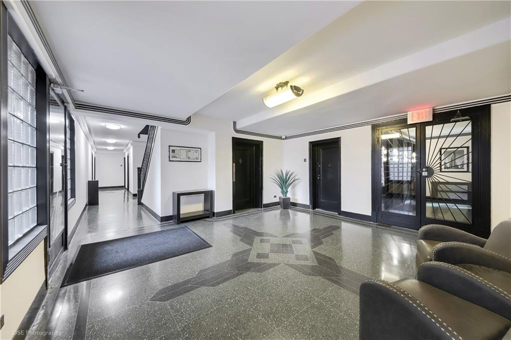 8701 Shore Road, Unit 137 Brooklyn, NY 11209 - Photo 9 of 11 a lobby with furniture and floor to ceiling window
