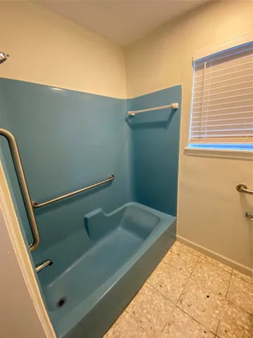 a bathroom with a tub and shower