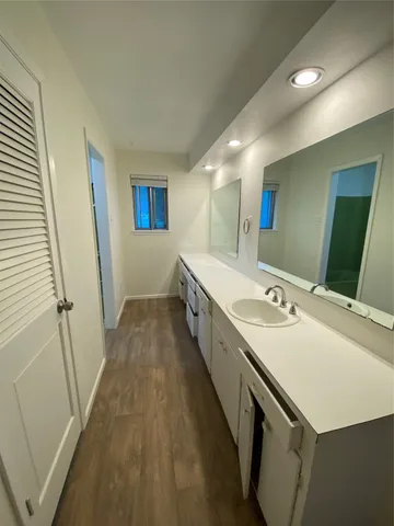 a large bathroom with a sink and a large mirror
