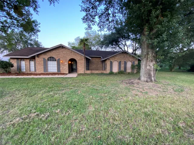 a big house with a big yard and large trees