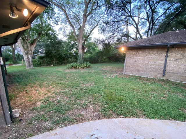 a view of a backyard with large trees