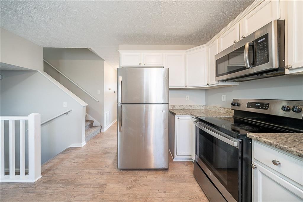 2183 Ramblewood Circle Decatur, GA 30035 - Photo 3 of 37 a kitchen with stainless steel appliances granite countertop a refrigerator stove and microwave