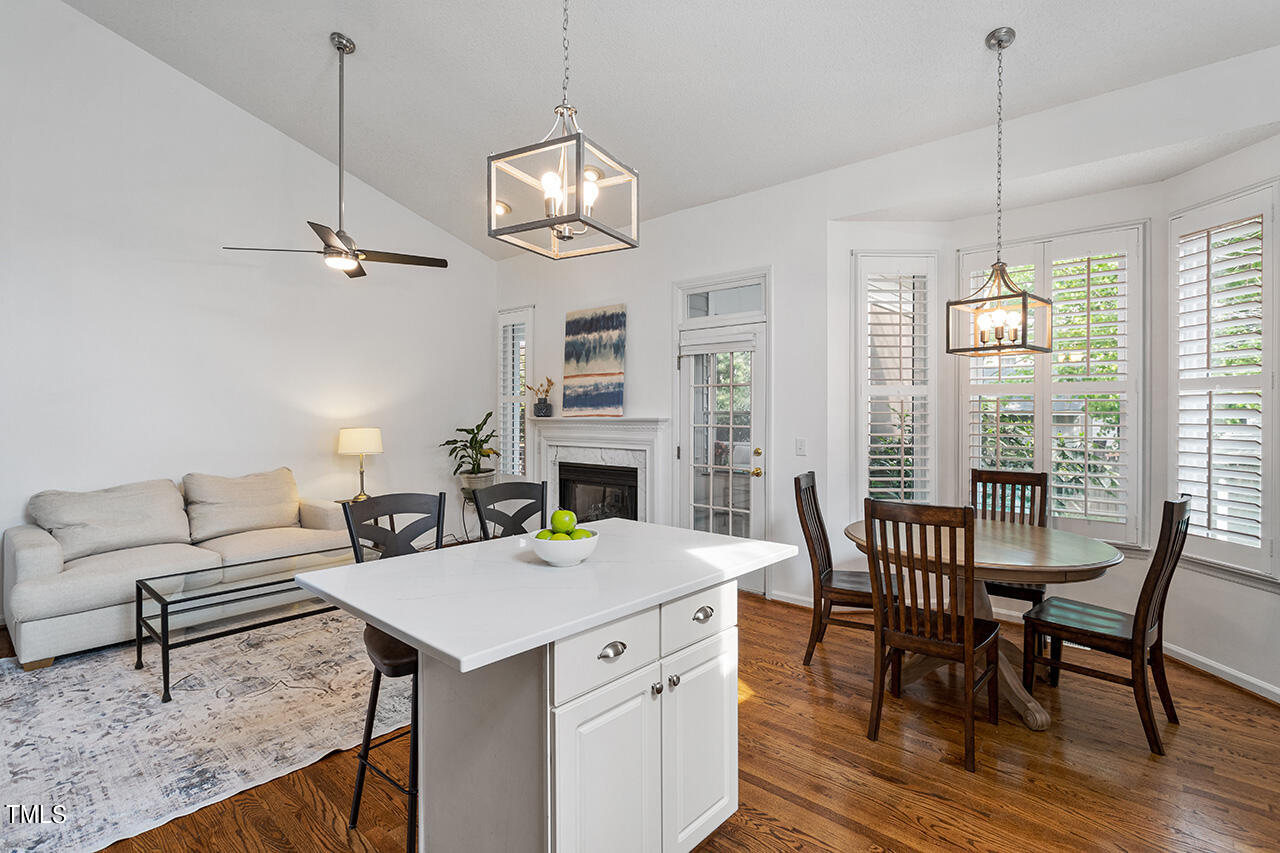 2320 Kendricks Court Raleigh, NC 27613 - Photo 14 of 35 a view of a dining room with furniture a chandelier and wooden floor