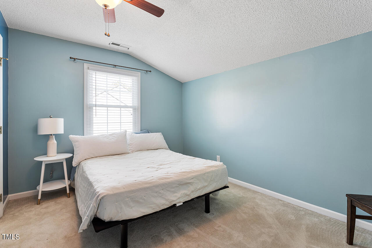 2320 Kendricks Court Raleigh, NC 27613 - Photo 27 of 35 a bedroom with a bed and a window