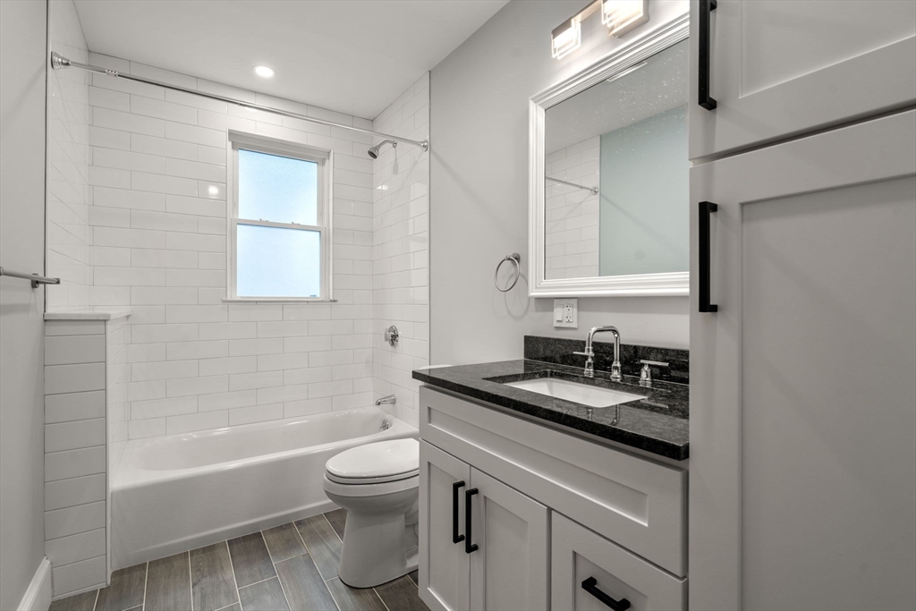21-23 Westmore Road Boston, MA 02126 - Photo 14 of 42 a bathroom with a granite countertop sink toilet and shower