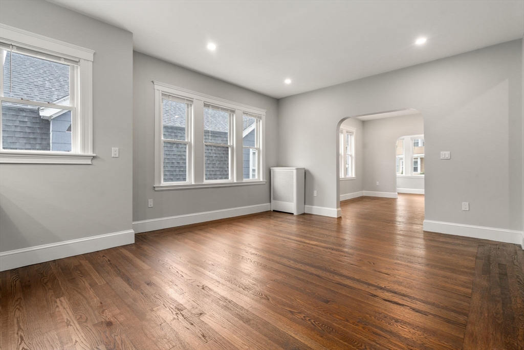 21-23 Westmore Road Boston, MA 02126 - Photo 23 of 42 a view of empty room with wooden floor and fan