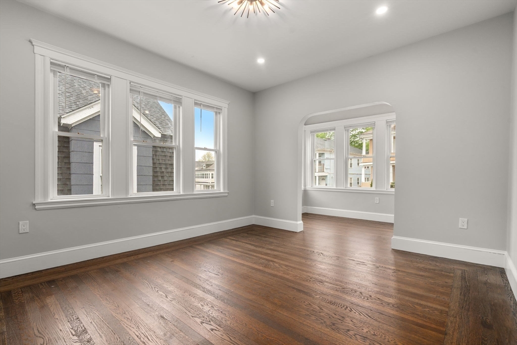 21-23 Westmore Road Boston, MA 02126 - Photo 24 of 42 a view of an empty room with wooden floor and a window