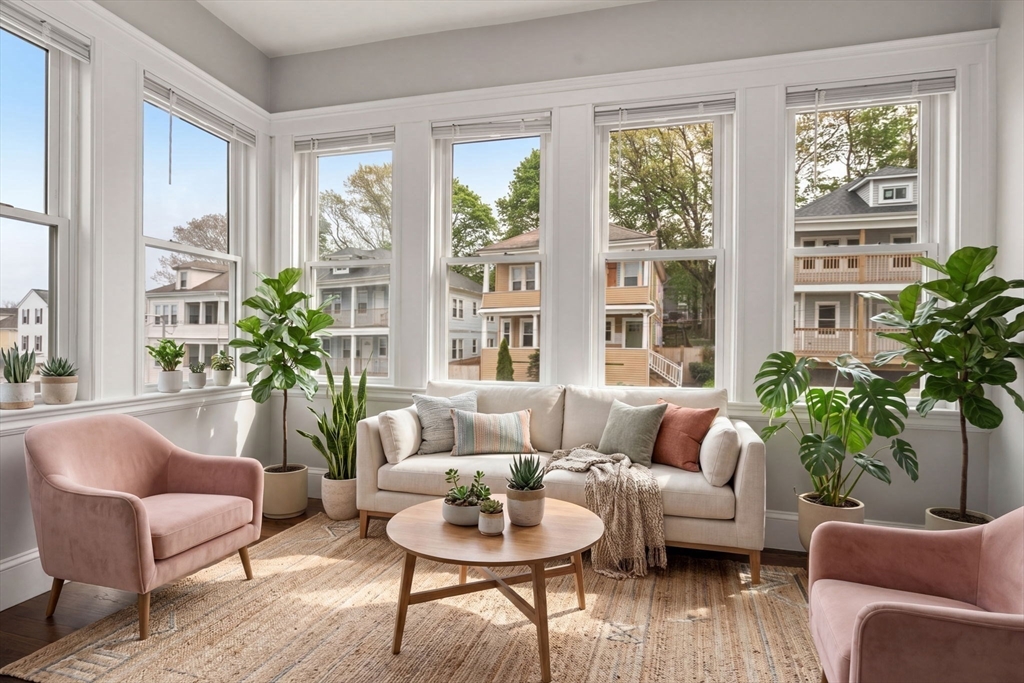 21-23 Westmore Road Boston, MA 02126 - Photo 27 of 42 a living room with furniture potted plant and windows