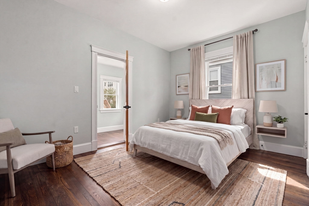 21-23 Westmore Road Boston, MA 02126 - Photo 32 of 42 a bedroom with a bed and wooden floor