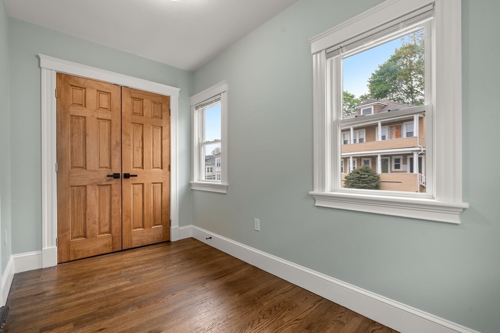 21-23 Westmore Road Boston, MA 02126 - Photo 33 of 42 a view of an empty room with wooden floor and a window