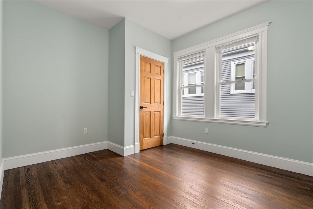 21-23 Westmore Road Boston, MA 02126 - Photo 36 of 42 a view of wooden floor and windows in a room