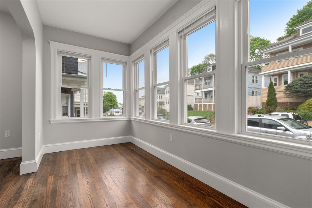 21-23 Westmore Road Boston, MA 02126 - Photo 4 of 42 a view of empty room with wooden floor and fan