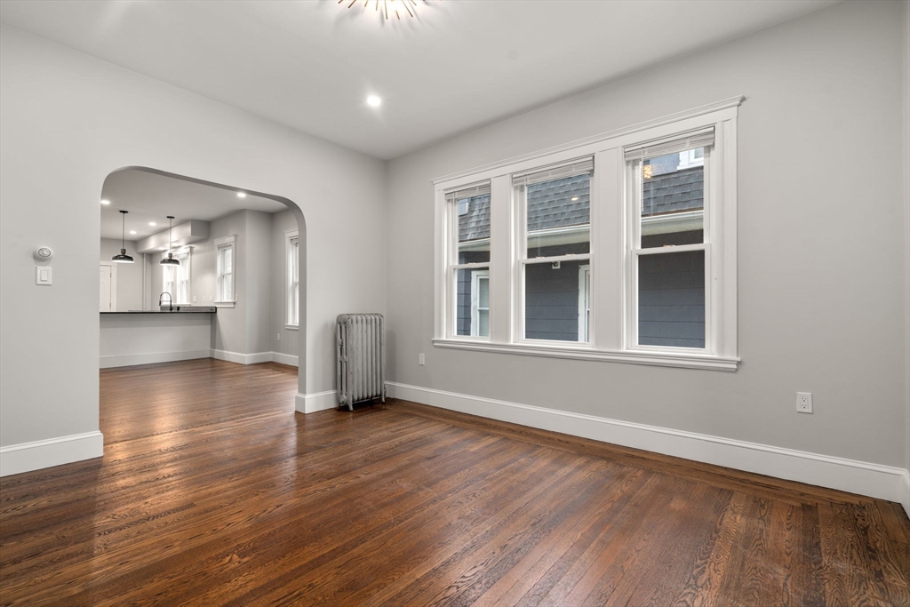 21-23 Westmore Road Boston, MA 02126 - Photo 5 of 42 a view of an empty room with wooden floor and a window