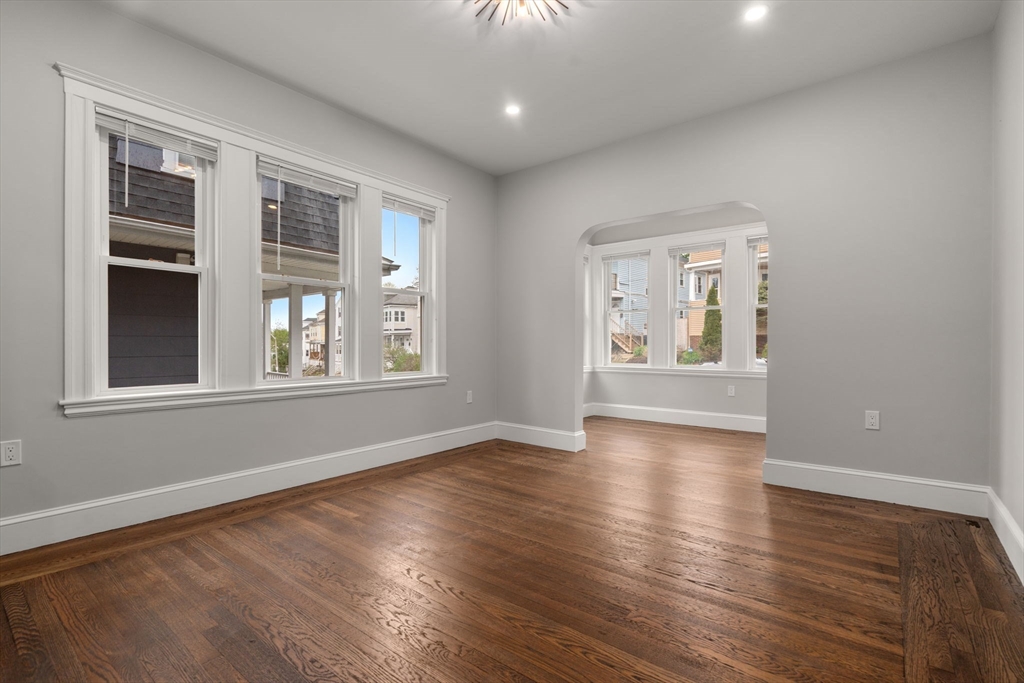 21-23 Westmore Road Boston, MA 02126 - Photo 6 of 42 a view of an empty room with wooden floor and a window