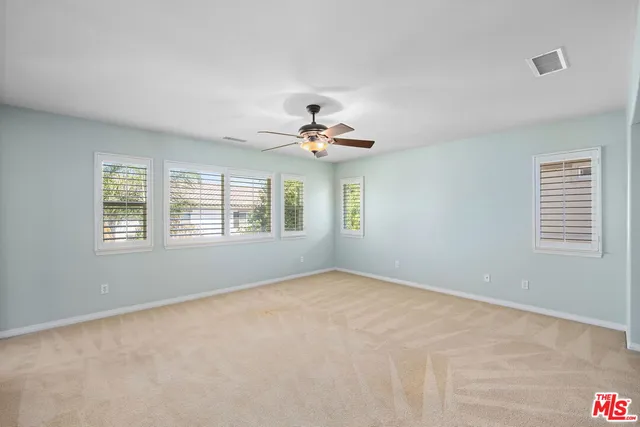 a view of a livingroom with a ceiling fan and window