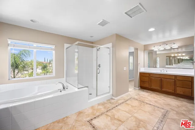 a large spacious bathroom with a large tub shower and sink