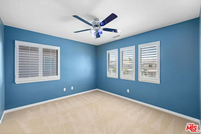 a view of a livingroom with a ceiling fan and window