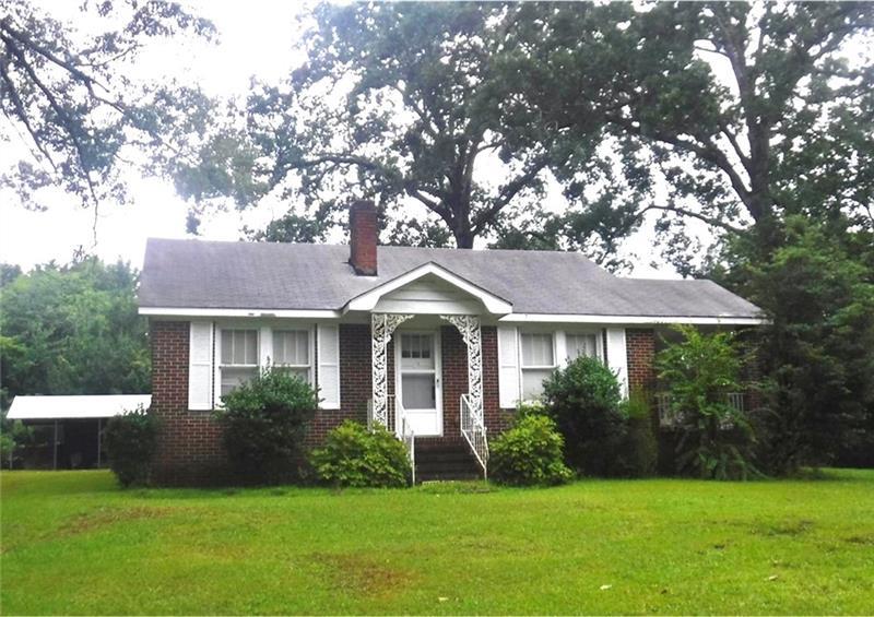 4800 Mosley Road Austell, GA 30106 - Photo 1 of 1 a front view of a house with a garden and yard