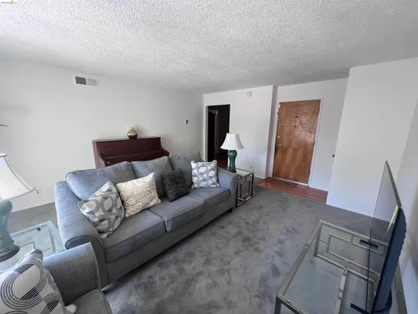 a bedroom with a bed lamp and a window