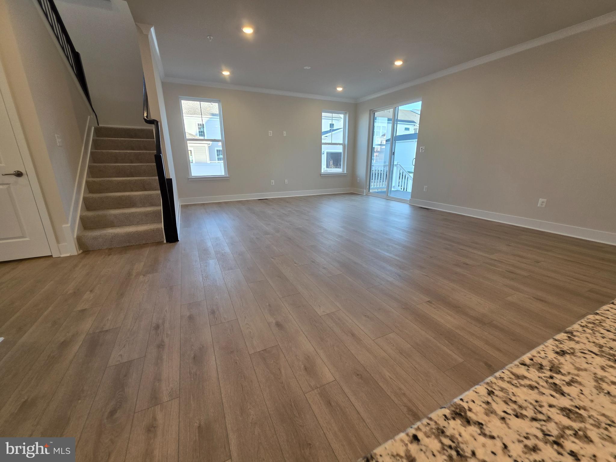 6511 Paddington Street Middle River, MD 21220 - Photo 18 of 46 a view of an empty room with wooden floor and stairs