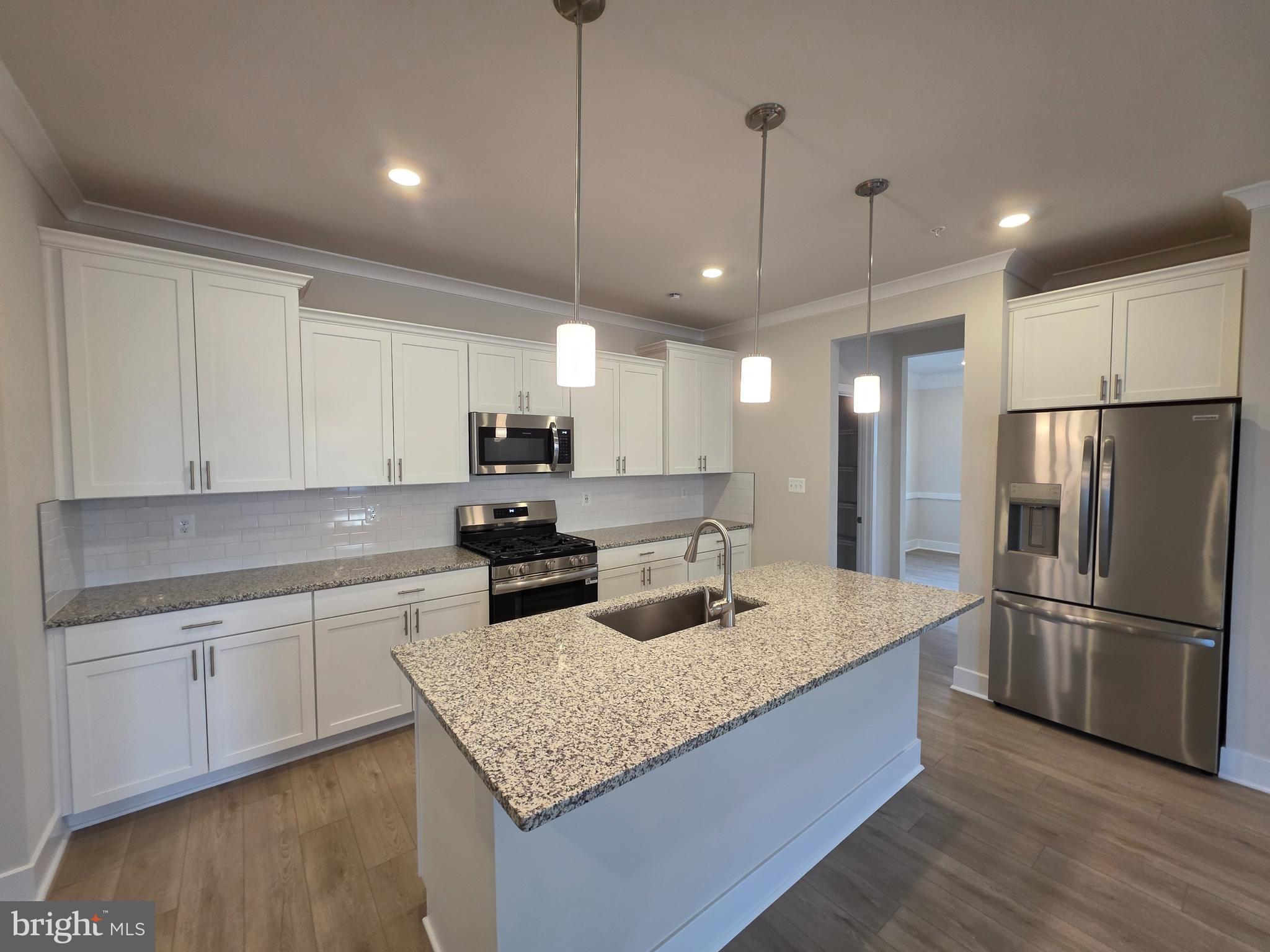 6511 Paddington Street Middle River, MD 21220 - Photo 21 of 46 a kitchen with stainless steel appliances granite countertop a sink refrigerator and microwave