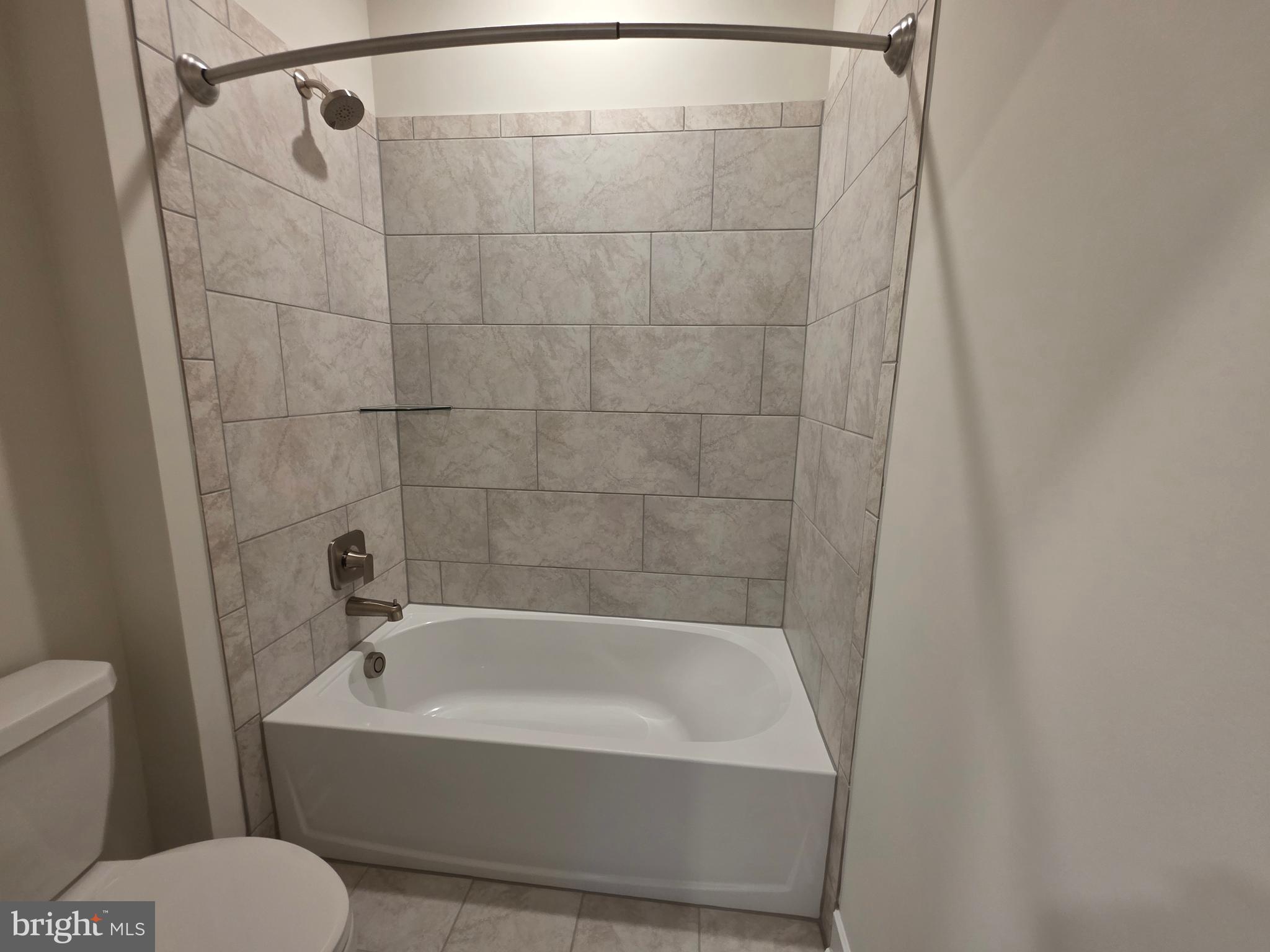 6511 Paddington Street Middle River, MD 21220 - Photo 32 of 46 a white bath tub sitting next to a white toilet