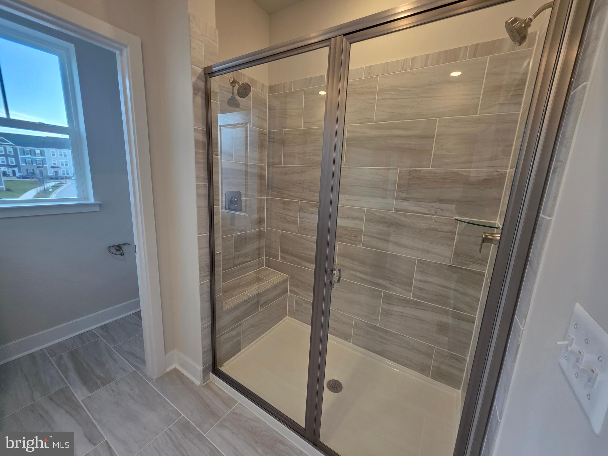 6511 Paddington Street Middle River, MD 21220 - Photo 38 of 46 a bathroom with a glass shower door