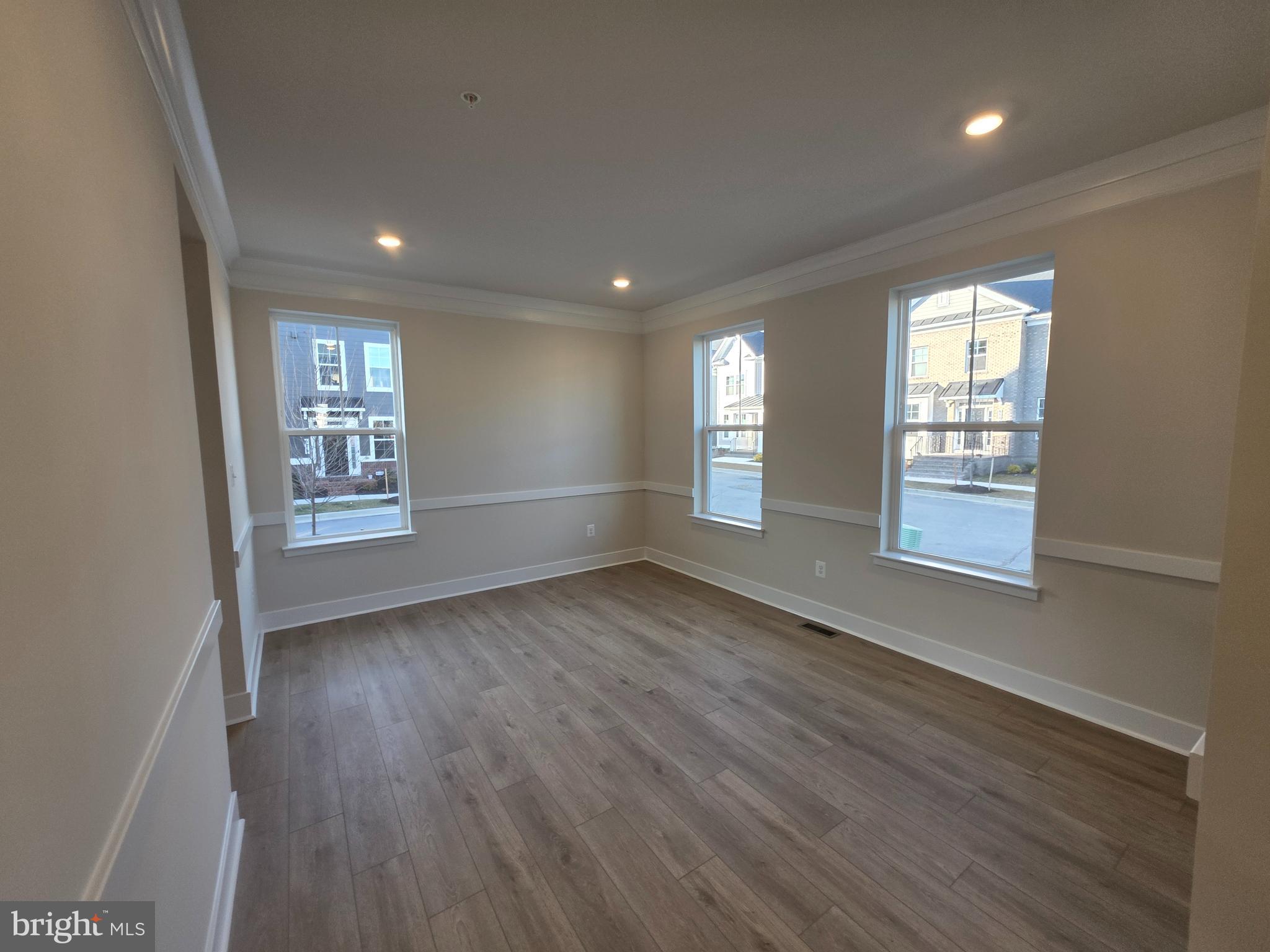 6511 Paddington Street Middle River, MD 21220 - Photo 10 of 46 a view of an empty room with wooden floor and a window