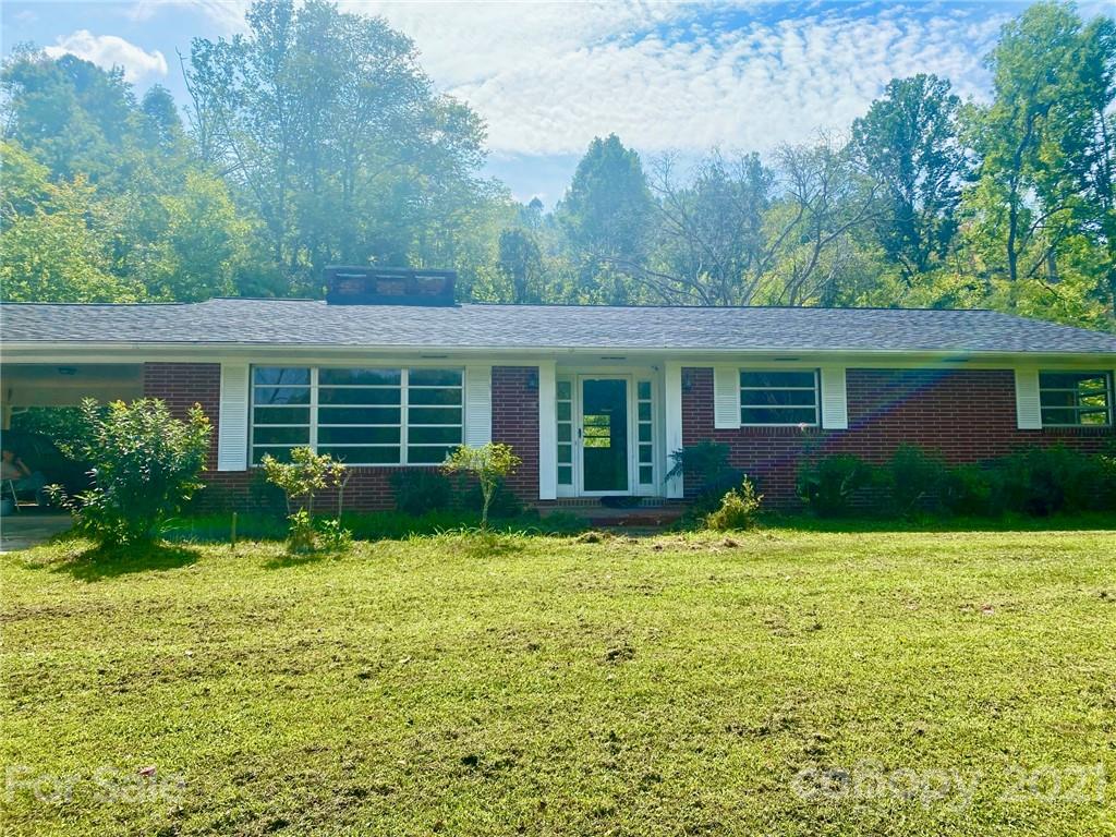 379 South Goforth Road Ferguson, NC 28624 - Photo 2 of 16 a front view of a house with a yard and garage