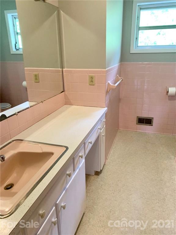379 South Goforth Road Ferguson, NC 28624 - Photo 11 of 16 a bathroom with a tub sink and a mirror